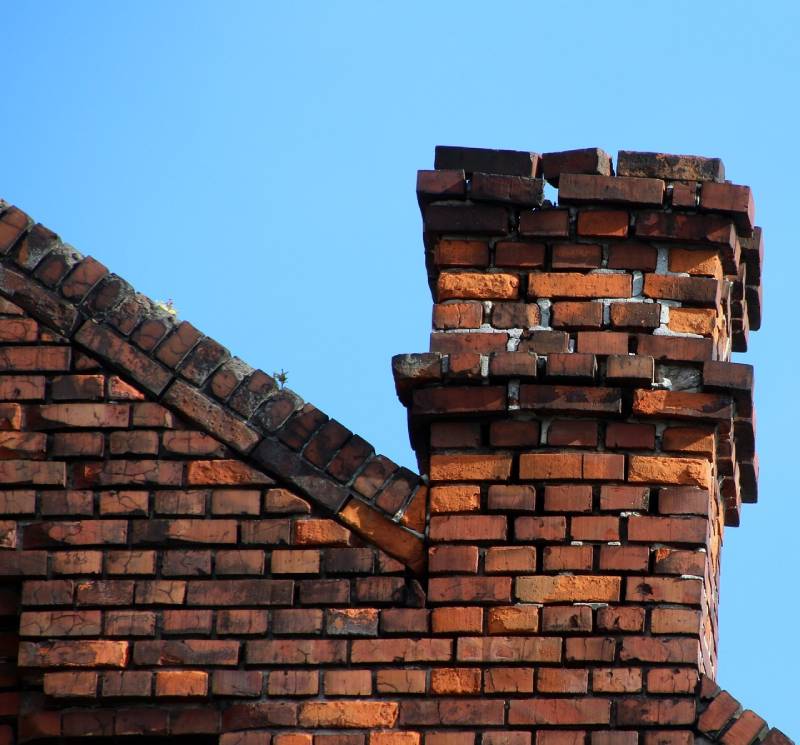 Signs Your Rochester Hills Home Needs a Chimney Inspection Damaged chimney on an Rochester Hills home showing cracks and missing mortar